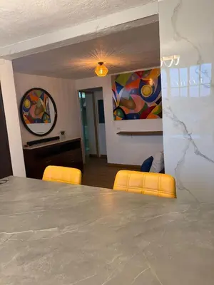 a dining room with a table and two chairs at Villa Napoli Apartment Suites in Santa Ana