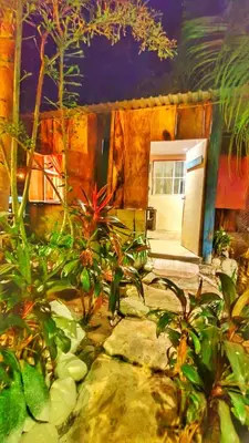a room with some plants and a white refrigerator at Sea Garden Mizata in Las Piedras