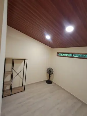 a room with a wooden ceiling and a fan at Cabaña en el campo