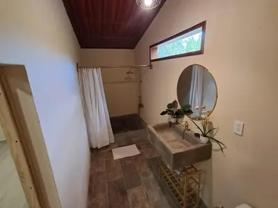 a bathroom with a sink and a mirror at Cabaña en el campo
