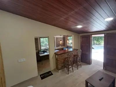 a kitchen with a bar and a desk in a house at Cabaña en el campo