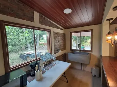 a kitchen with a table and a sink and a window at Cabaña en el campo