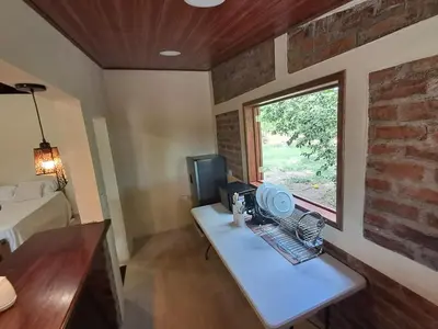 a small room with a table and a window at Cabaña en el campo