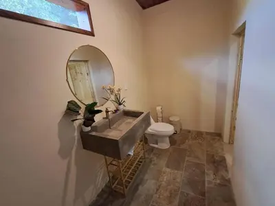 a bathroom with a sink and a toilet at Cabaña en el campo
