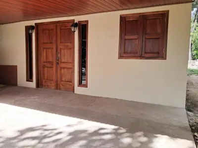 a house with two wooden doors and a patio at Cabaña en el campo