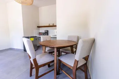 a kitchen with a wooden table and chairs at Rancho San Jose - Barra De Santiago in Barra de Santiago