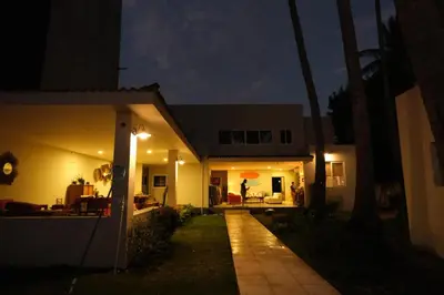 a house at night with the lights on at Casa Origen El Zonte in El Zonte
