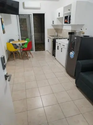 a kitchen and dining room with a table and chairs at House Haciendas del Mediterraneo in Ahuachapán
