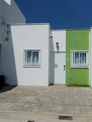 a white and green building with two doors at House Haciendas del Mediterraneo in Ahuachapán
