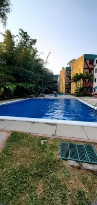 a large blue swimming pool on the side of a building at KR apartment CENTRO HISTÓRICO, SAN SALVADOR, TRES HABITACIONES 4 CAMAS parking wifi netflix VIX y mas in San Salvador