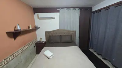 a small bedroom with a bed in a room at KR apartment CENTRO HISTÓRICO, SAN SALVADOR, TRES HABITACIONES 4 CAMAS parking wifi netflix VIX y mas in San Salvador