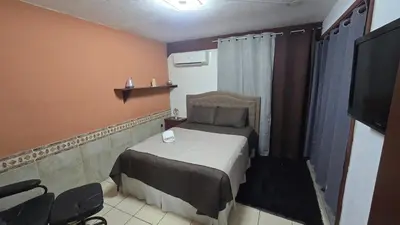 a small bedroom with a bed and a television at KR apartment CENTRO HISTÓRICO, SAN SALVADOR, TRES HABITACIONES 4 CAMAS parking wifi netflix VIX y mas in San Salvador