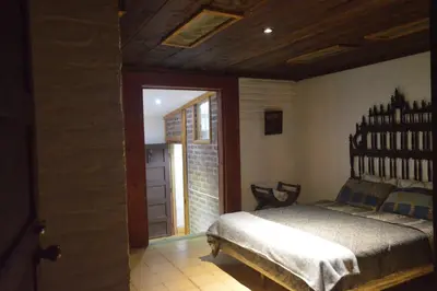a bedroom with a large bed in a room at Hostal y Restaurante Chilltepe Ataco in Concepción de Ataco
