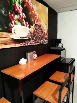 a table with a coffee cup and a picture on the wall at Flamingo loft in La Puerta de La Laguna