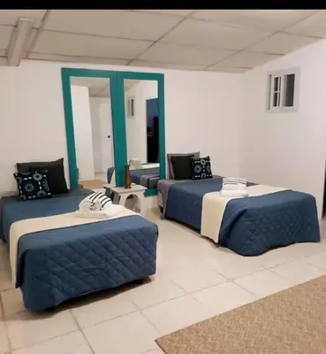 a room with three beds and a couch at Flamingo loft in La Puerta de La Laguna