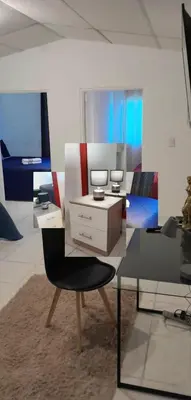 a living room with a chair and a desk at Flamingo loft in La Puerta de La Laguna