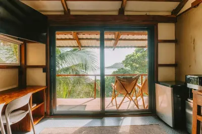 a kitchen with a sliding glass door leading to a patio at Punta Mango Villas in La Periquera