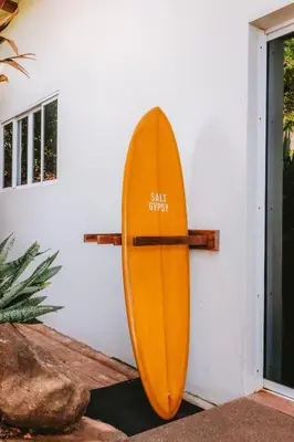 a wooden surfboard leaning against a wall at Punta Mango Villas in La Periquera