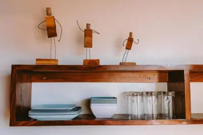 a wooden shelf with plates and glasses on it at Punta Mango Villas in La Periquera