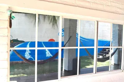 a window with a painting of a boat at The Salty Dogs in Playa San Blas