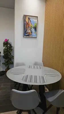 a white table with chairs and a picture on the wall at Confort en La Unión in La Unión