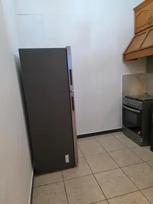 a kitchen with a black refrigerator and a stove at Confort en La Unión in La Unión