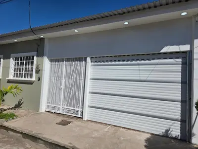 a white garage door on the side of a house at Confort en La Unión in La Unión