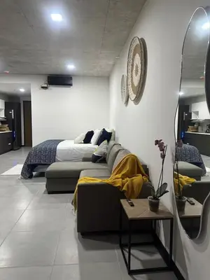a living room with a couch and a bed at Beko San Benito in San Salvador