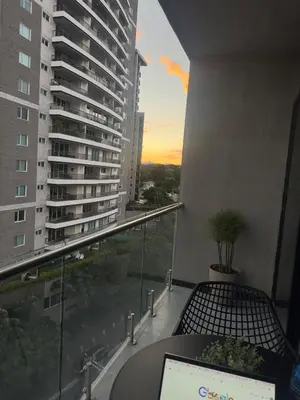 a balcony with a table and a view of a building at Beko San Benito in San Salvador