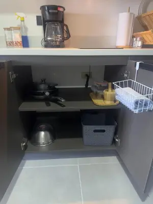 a kitchen counter with a sink and a shelf at Beko San Benito in San Salvador
