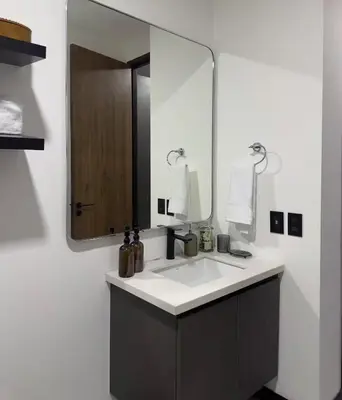 a bathroom with a sink and a large mirror at Beko San Benito in San Salvador