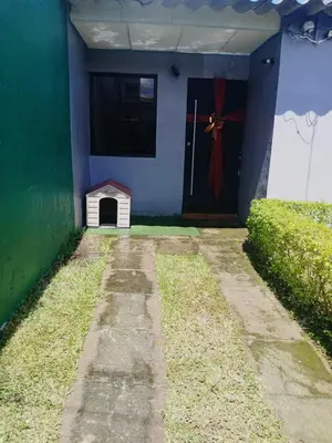 a blue house with a door and a dog house at Casa amplia y comoda in San Salvador