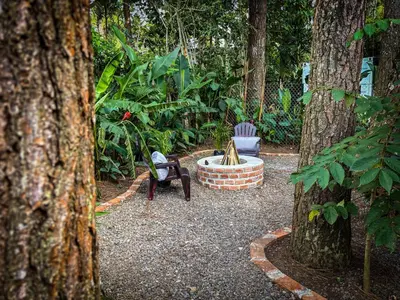 a garden with a fire pit between two trees at Umbra in Concepción de Ataco