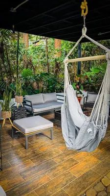 a porch with a hammock and a swing at Umbra in Concepción de Ataco