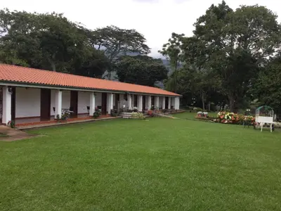 a building with a large yard in front of it at San Antonio Hotel Boutique in Los Naranjos