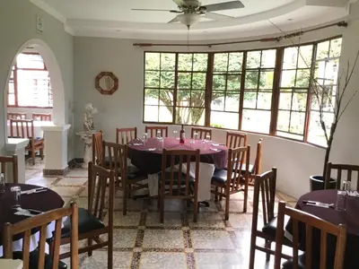 a dining room with a table and chairs at San Antonio Hotel Boutique in Los Naranjos