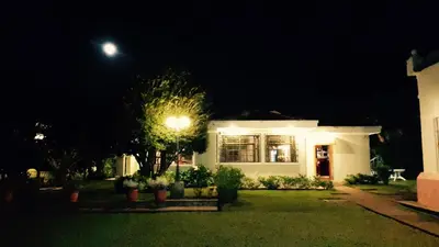 a house with a street light in front of it at night at San Antonio Hotel Boutique in Los Naranjos