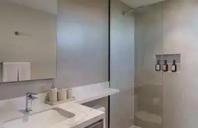 a white bathroom with a sink and a shower at Spacious 2BR 2BTH El Zonte with oceanview and pool in El Zonte