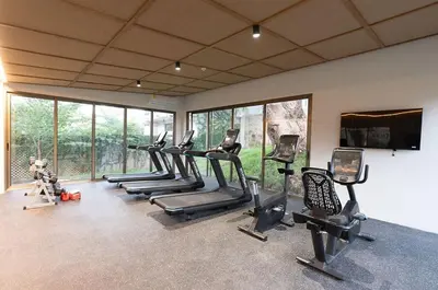 a gym with a row of treadms and cardio machines at Spacious 2BR 2BTH El Zonte with oceanview and pool in El Zonte