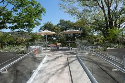 a patio with umbrellas and chairs and tables at Spacious 2BR 2BTH El Zonte with oceanview and pool in El Zonte