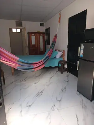 a room with a hammock in a living room at The Best Place for You to Relax