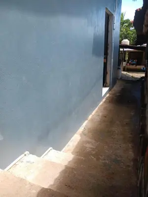 a blue wall next to a building with a doorway at The Best Place for You to Relax