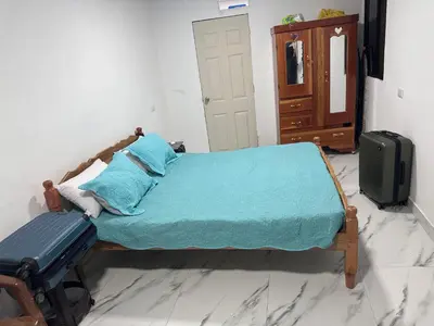 a bedroom with a bed with a suitcase and a dresser at The Best Place for You to Relax