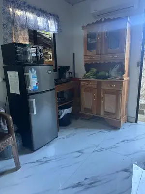 a kitchen with a refrigerator and a wooden cabinet at The Best Place for You to Relax