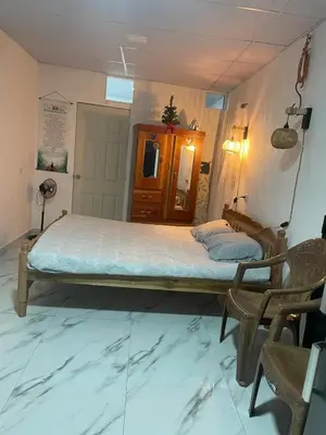 a bedroom with a large bed in a room with chairs at The Best Place for You to Relax
