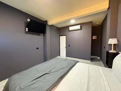 a large bed in a room with a television at Bella Habitación El Mangal B&B in Suchitoto