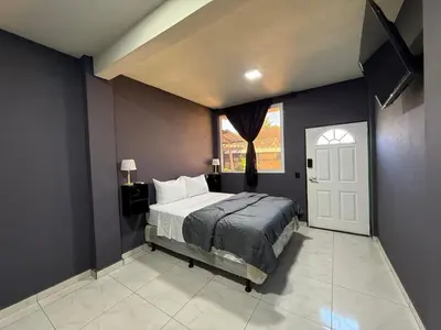 a bedroom with a bed and a window and a door at Bella Habitación El Mangal B&B in Suchitoto