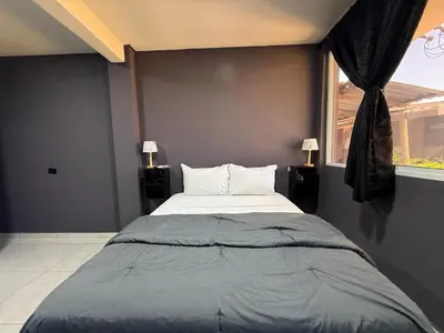 a bedroom with a bed and a window at Bella Habitación El Mangal B&B in Suchitoto