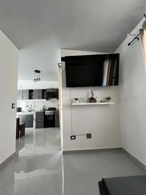 a living room with a flat screen tv on the wall at Home Sweet Home in San Miguel