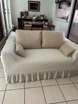 a white couch sitting on the floor in a living room at ZonaTorre Futura WTC comfy spacious little house! in San Salvador